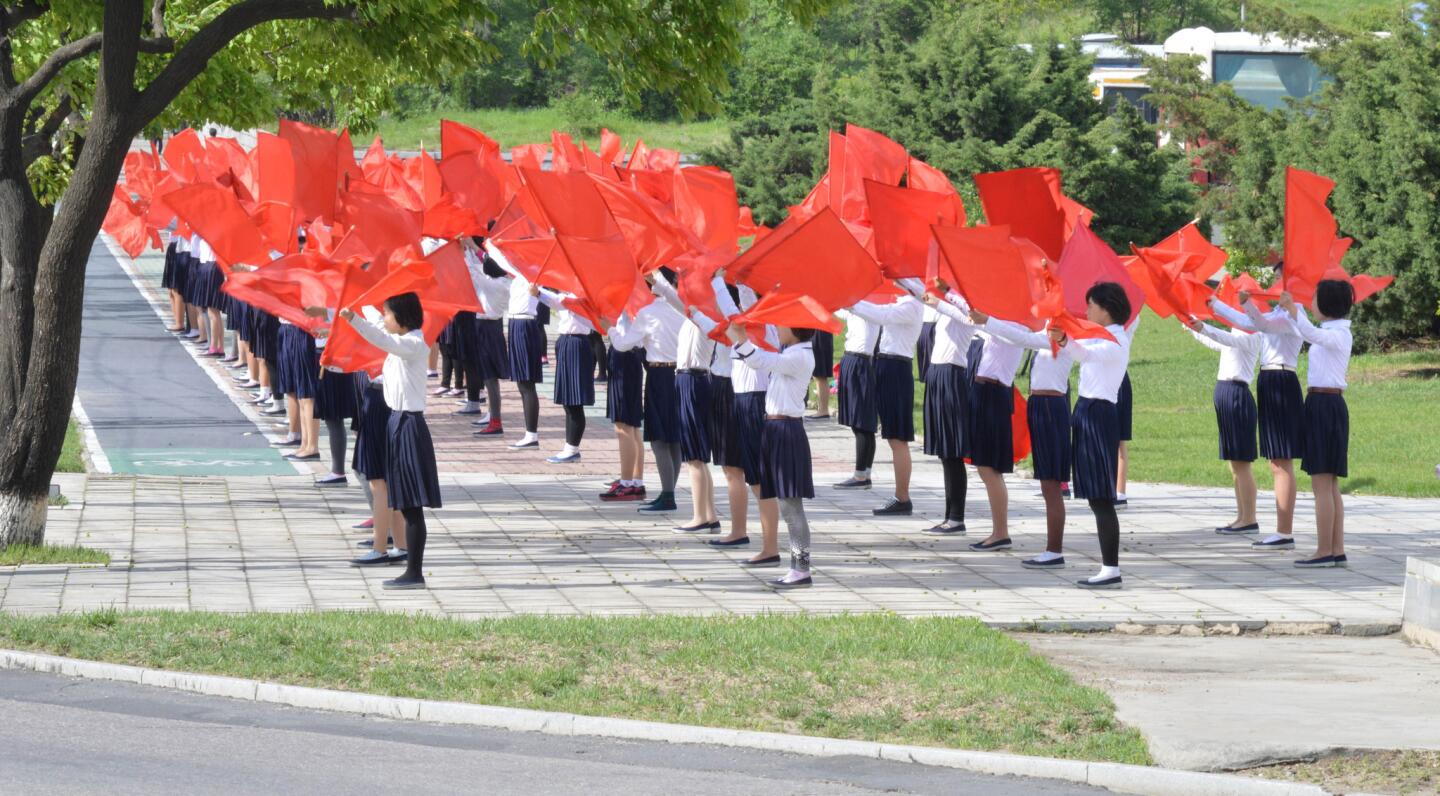 Girls practice a flag routine to be performed during celebrations for the Workers' Party Congress.