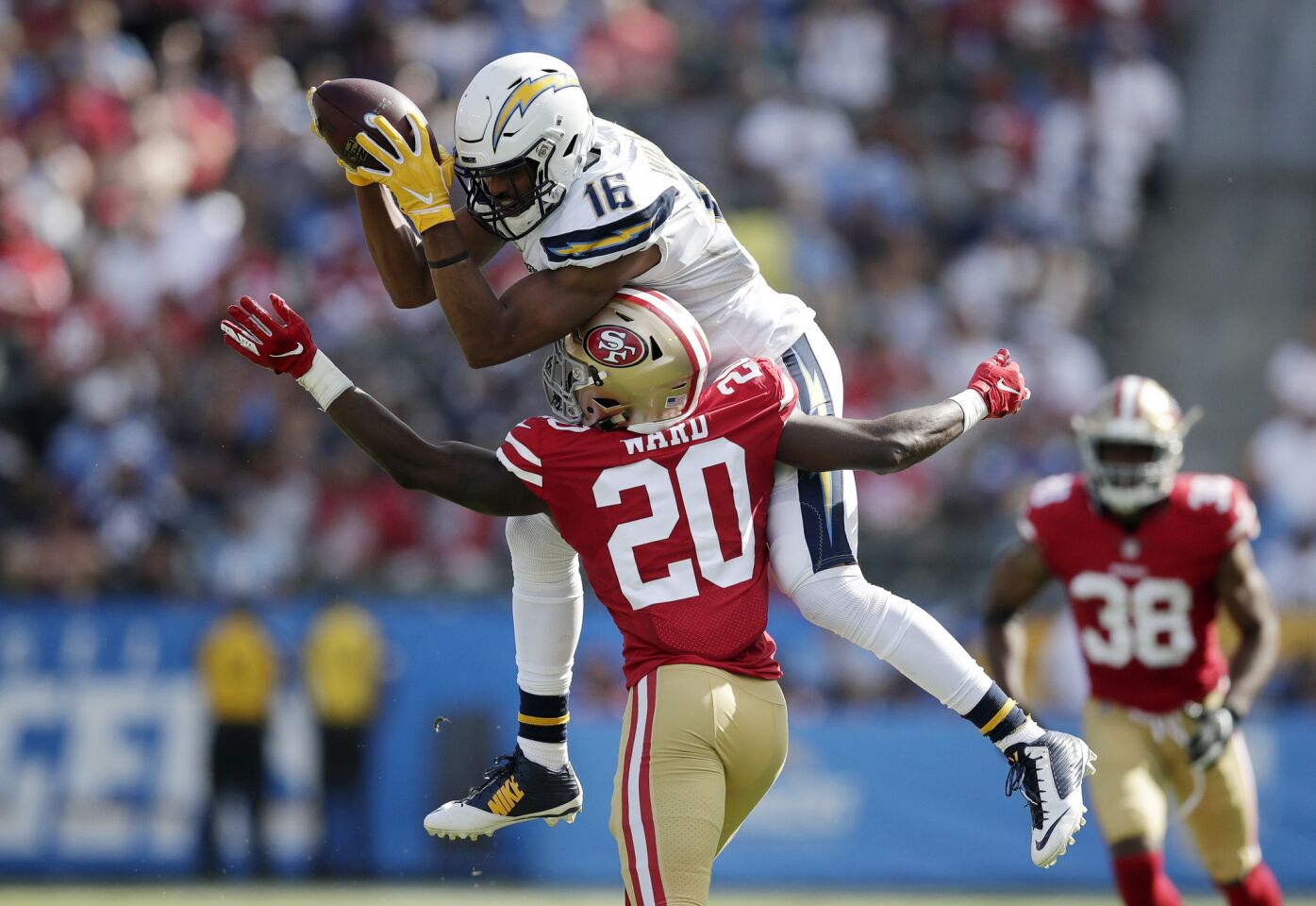 Los Angeles Chargers wide receiver Tyrell Williams, top, makes a catch while under pressure from San Francisco 49ers defensive back Jimmie Ward during the second half of an NFL football game, Sunday, Sept. 30, 2018, in Carson, Calif.