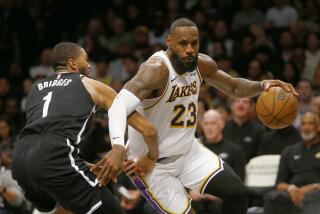 Los Angeles Lakers forward LeBron James (23) drives around Brooklyn Nets guard Mikal Bridges.