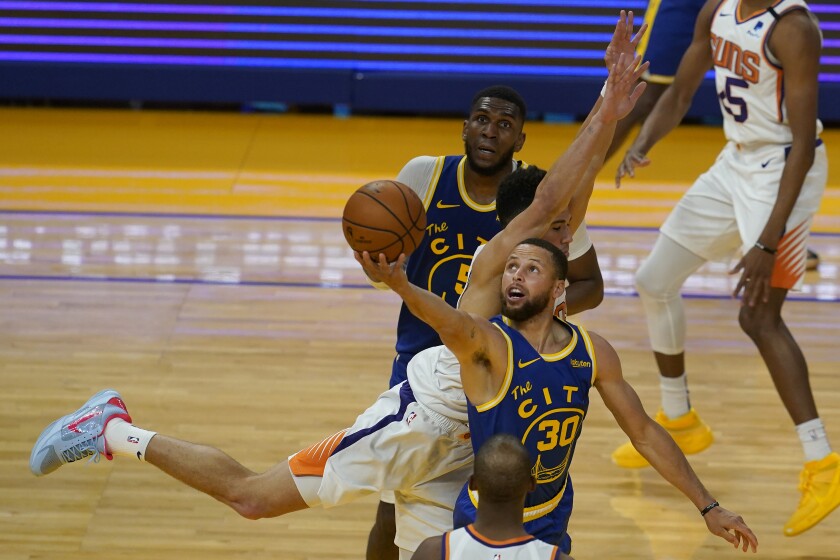 Golden State Warriors guard Stephen Curry (30) shoots against Phoenix Suns guard Devin Booker during the second half of an NBA basketball game in San Francisco, Tuesday, May 11, 2021. (AP Photo/Jeff Chiu)