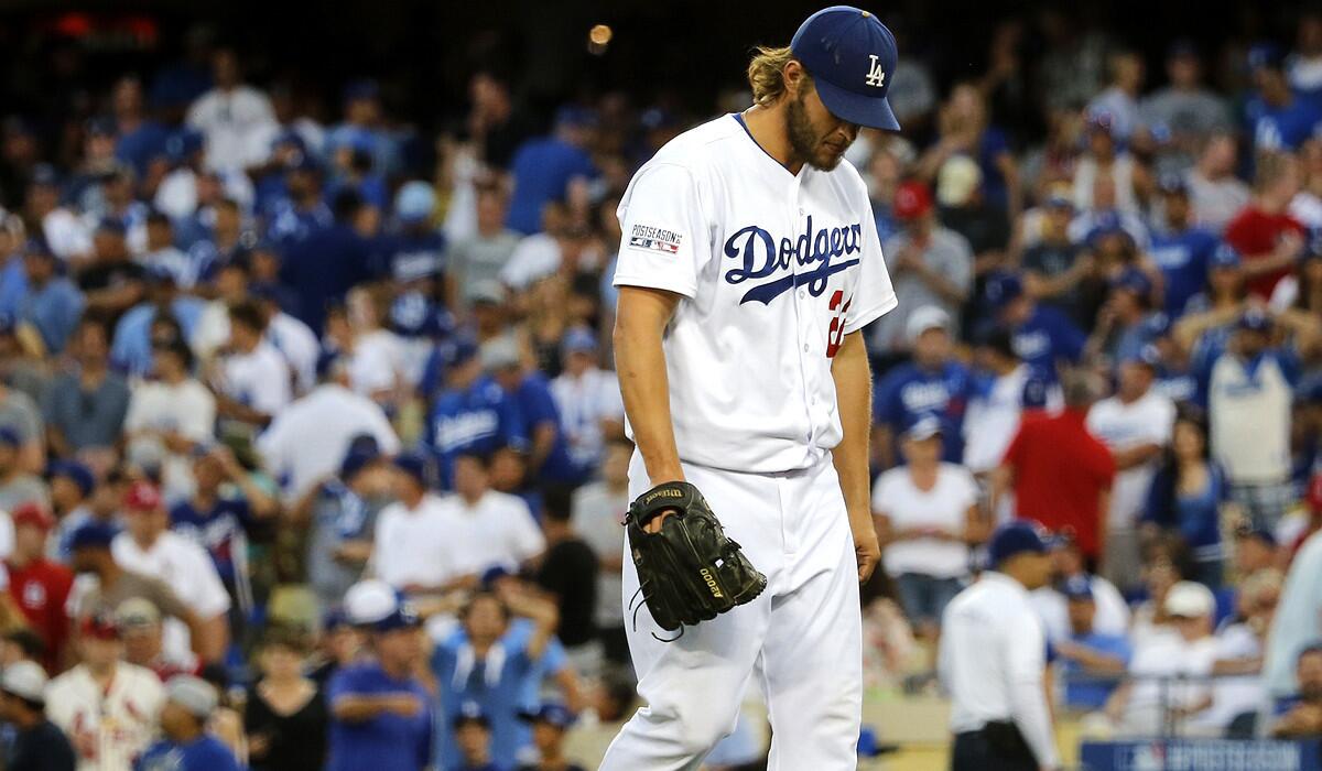 Dodgers starting pitcher Clayton Kershaw heads to the dugout after being replaced during the Cardinals' eight-run seventh inning in Game 1 of the NLDS on Friday night at Dodger Stadium.