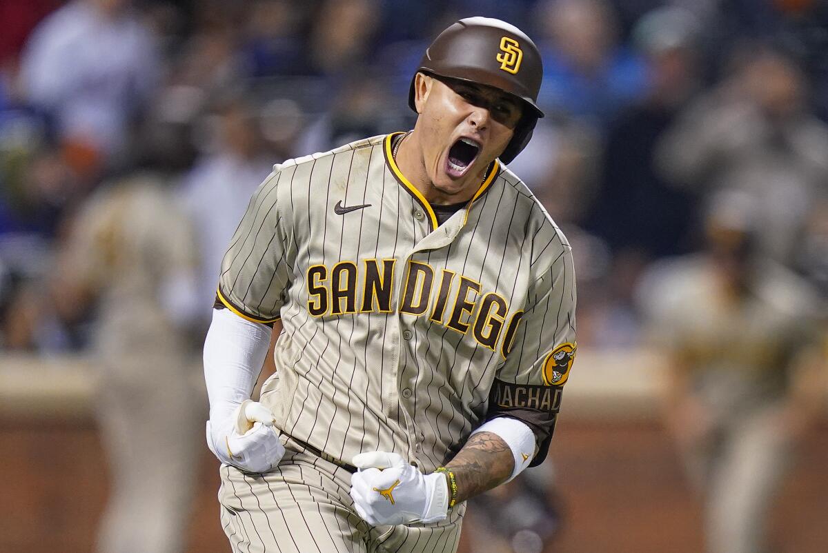San Diego Padres Manny Machado reacts as he rounds the bases after hitting a solo home run.