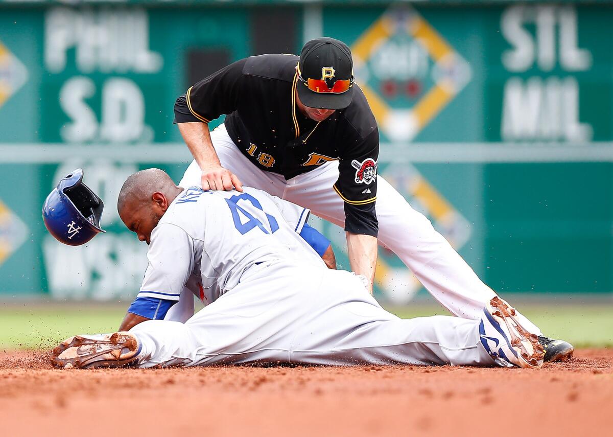 The Dodgers' Howie Kendrick beats the tag of Pirates second baseman Neil Walker during a pickoff attempt at second base in the second inning of their game Saturday in Pittsburgh. No review needed on this play.