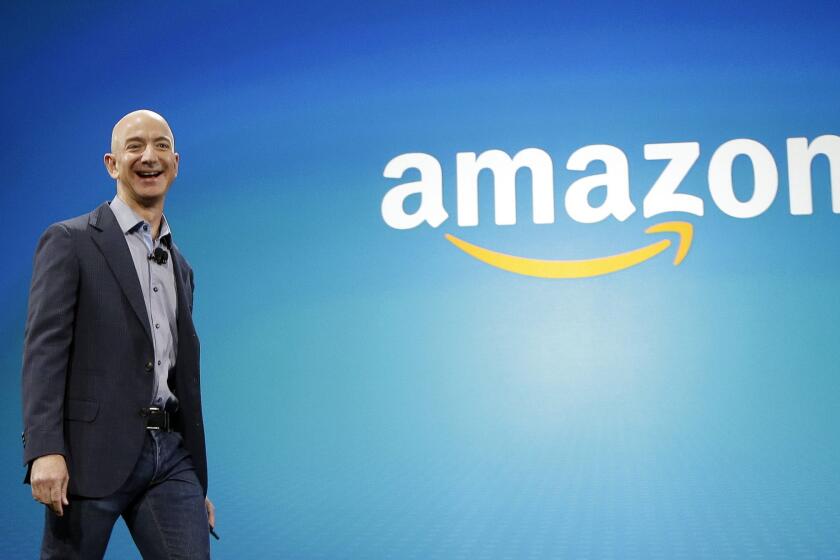 Amazon CEO Jeff Bezos walks onstage for the launch of the Fire Phone last year in Seattle.