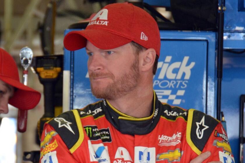 Dale Earnhardt Jr., stands in the garage during a practice for Sunday's NASCAR Cup Series auto race a at Texas Motor Speedway in Fort Worth, Texas, Saturday, April 8, 2017. (AP Photo/Randy Holt)