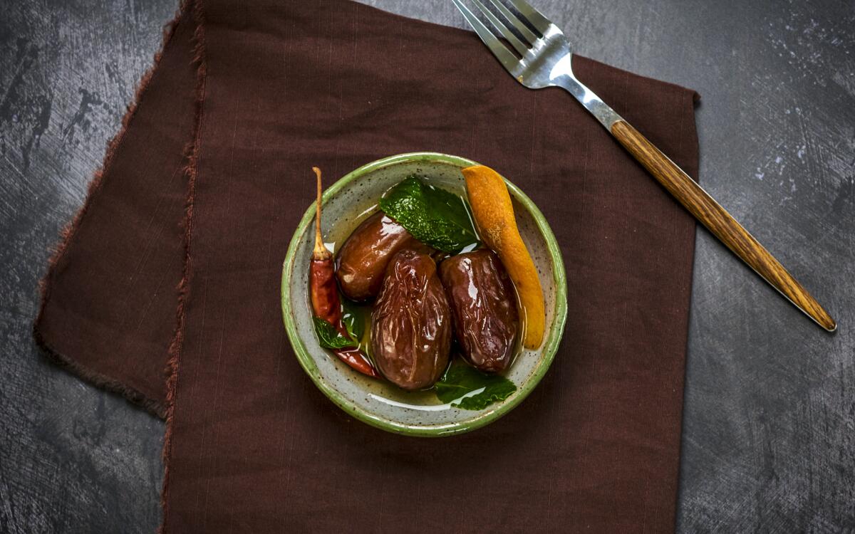 Dried chiles, orange zest and fresh mint add zing to sweet dates in this aromatic snack.