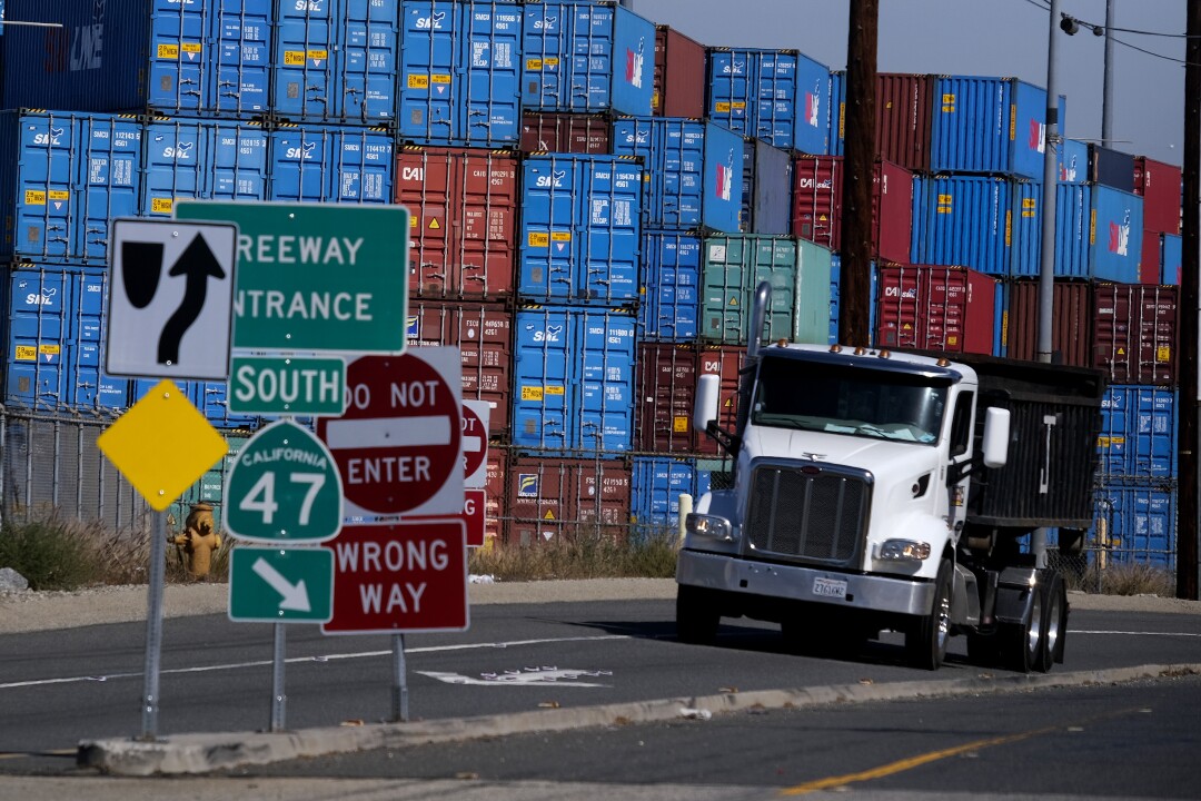 Cargo containers sit stacked at the Port of Los Angeles, Wednesday Oct. 20, 2021 