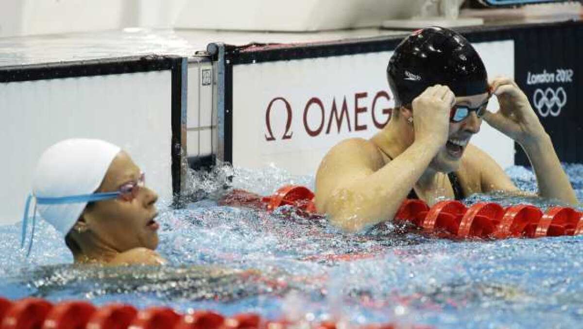 Allison Schmitt, right, reacts after winning the gold medal.