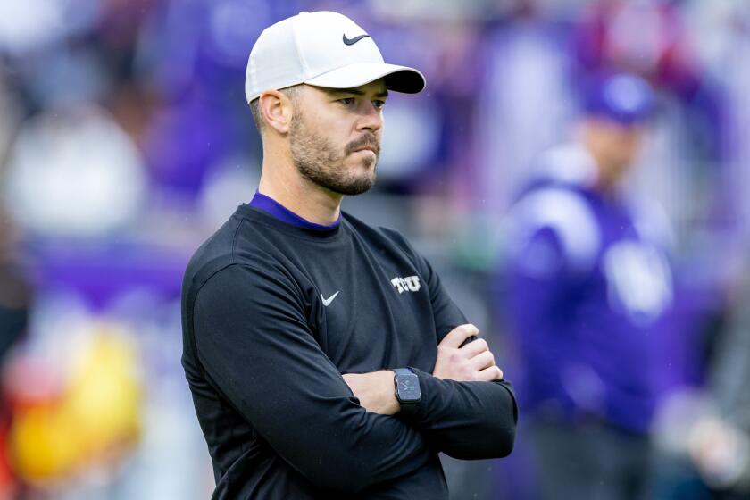 FORT WORTH, TX - NOVEMBER 26: TCU offensive coordinator Garrett Riley looks on during warmups.