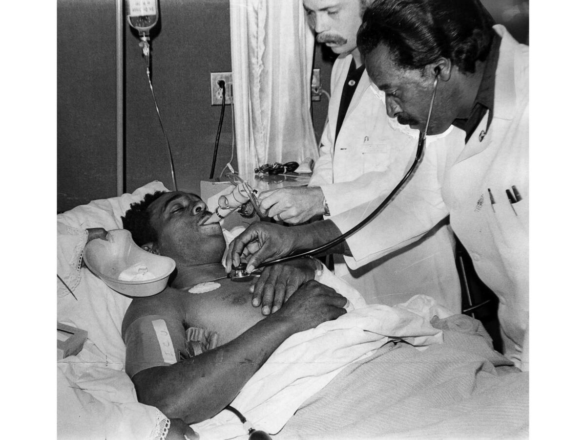 June 24, 1971: Ralph Brissette, found alive in tunnel after explosion, is attended by doctors at a hospital.