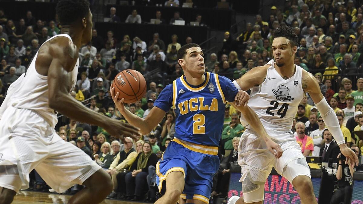 UCLA's Lonzo Ball tries to get around Oregon's Dillon Brooks, right, on Dec. 28.