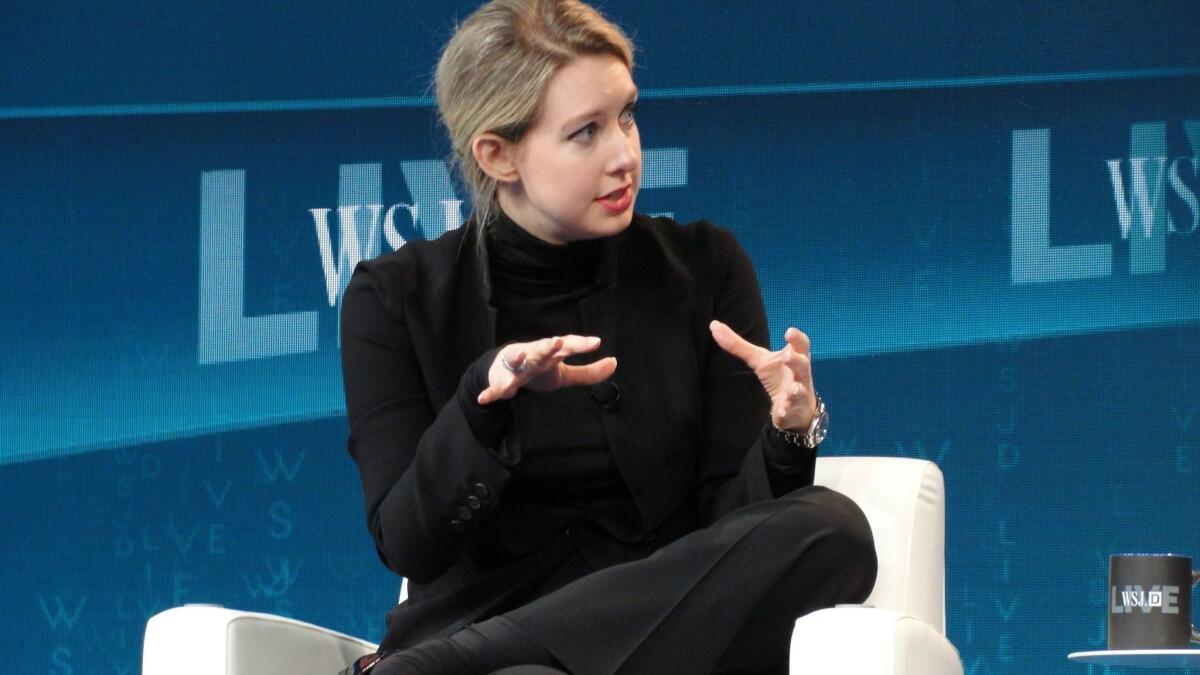 Theranos' then-CEO Elizabeth Holmes speaks at a Wall Street Journal technology conference in Laguna Beach in 2015. She agreed Wednesday to forfeit stock, pay a fine and relinquish control of her company to settle SEC fraud allegations.