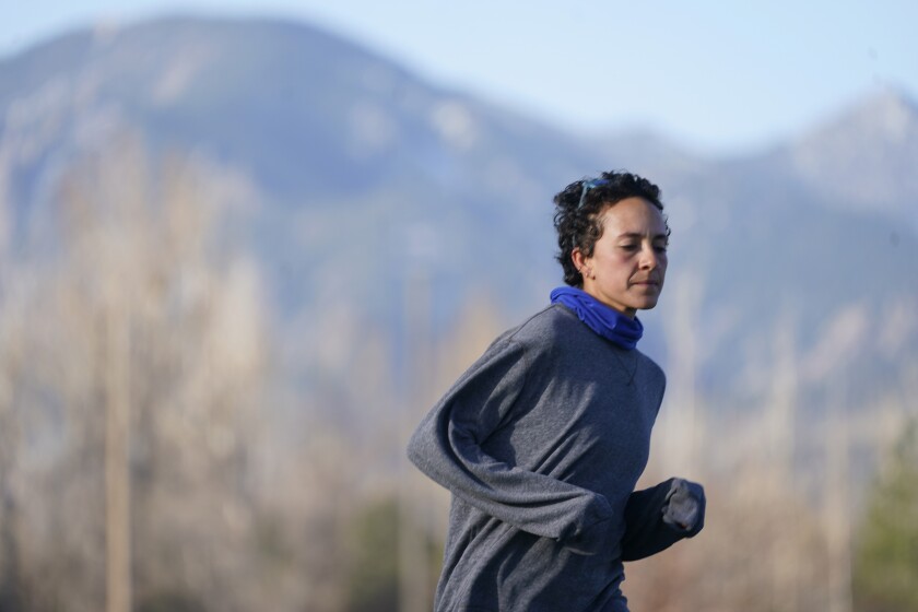 Runner Maggie Montoya is shown as she trains with fellow runners at a park on the east side of Boulder, Colo., Friday, April 9, 2021. The Olympic hopeful was working in the pharmacy at the King Soopers supermarket in Colorado on March 22 when 10 people were killed in the mass shooting. The next day, Montoya was picked up by her dad and taken home to Arkansas. It was a chance to be with family and remember those who lost their lives.(AP Photo/David Zalubowski)