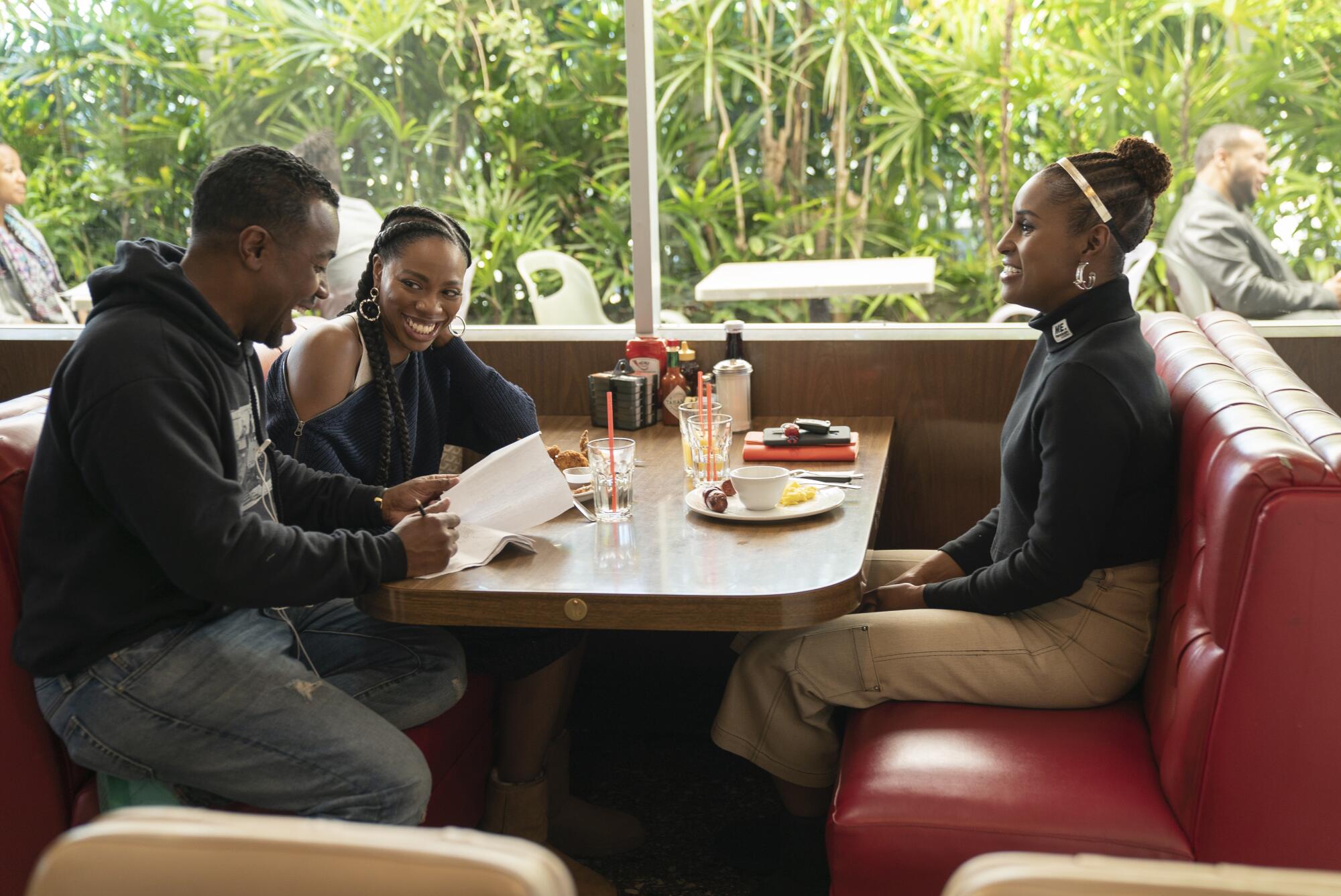 Prentice Penny on the set of Season 3 of "Insecure" with actresses Yvonne Orji and Issa Rae.