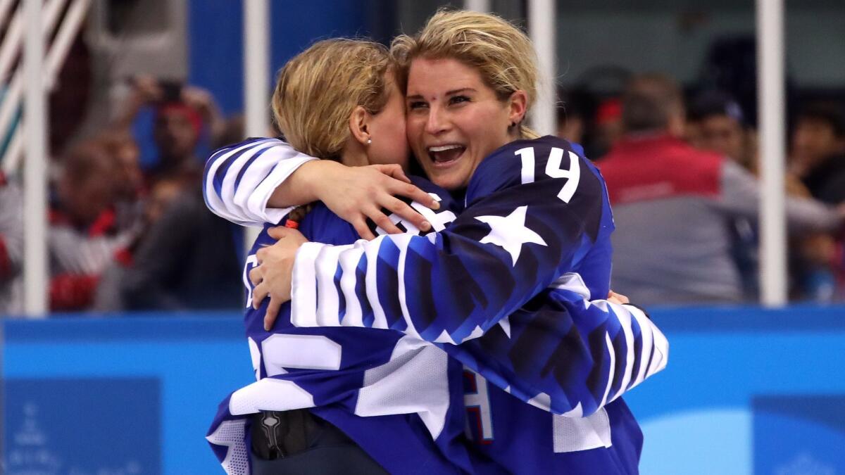 Brianna Decker (14) embraces a teammate after the U.S. defeated Canada in the gold-medal game of the 2018 Winter Olympics.