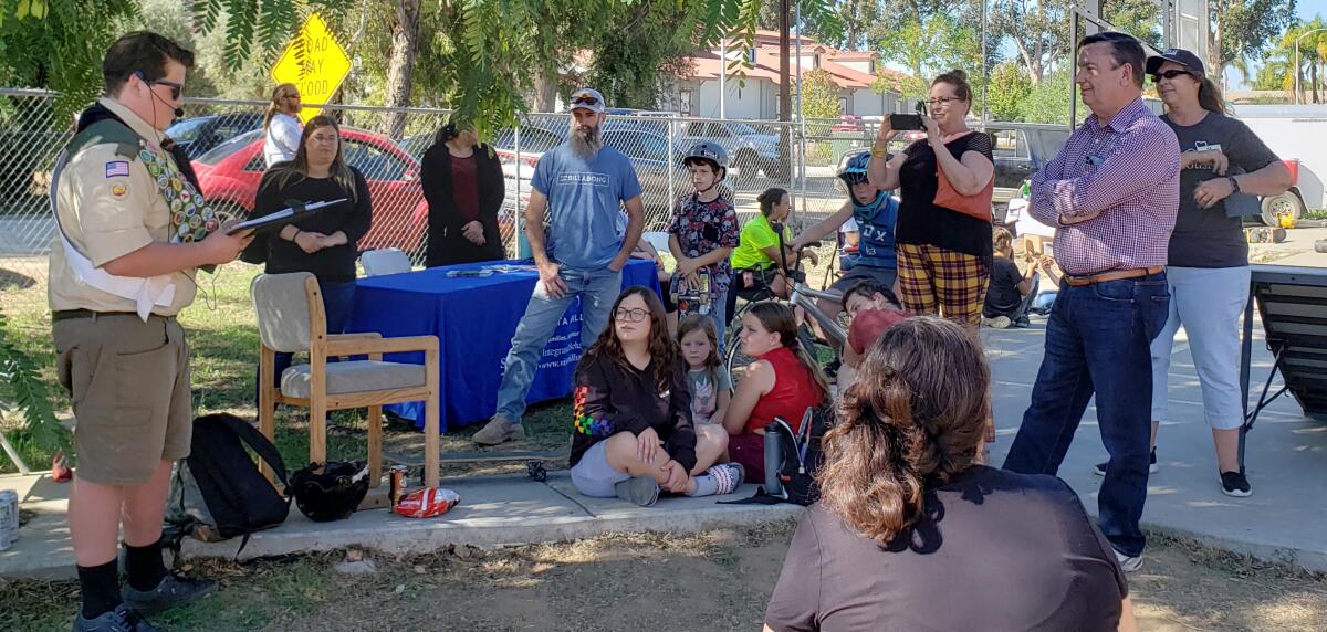 Boy Scout Brando Duran, left, tells Supervisor Joel Anderson how beneficial the pop-up skatepark is to him and the community.