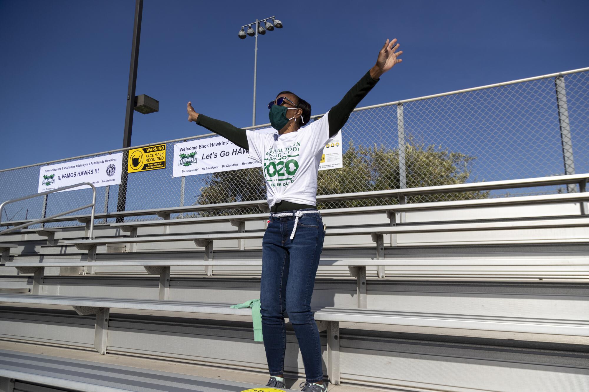 Kelly Bedford cheers on her son, Hawkins linebacker Patrick Reese, during a season-opening game on April 9, 2021.