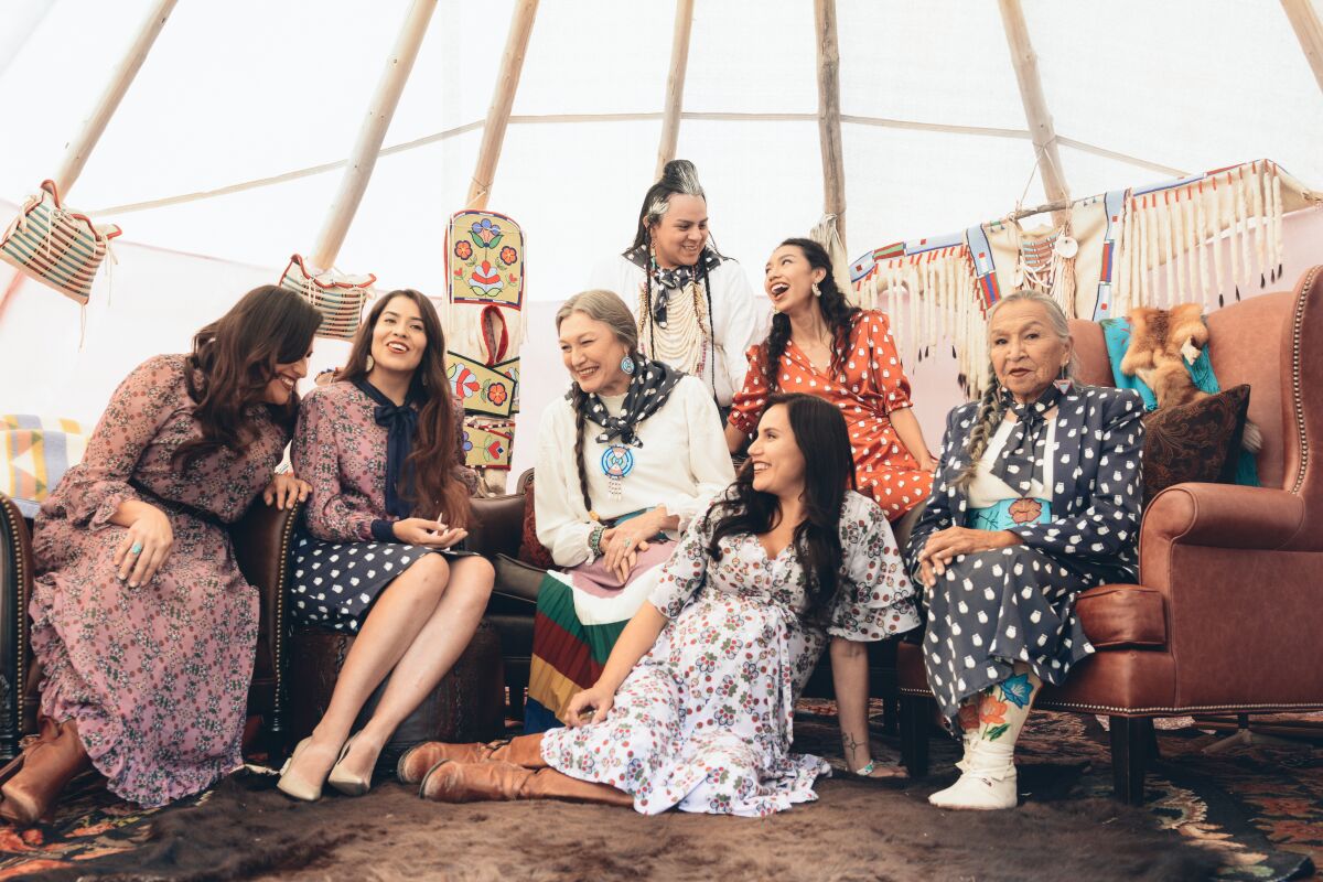 Native American models across generations gather inside a tepee to model B.Yellowtail's Heritage Collection.