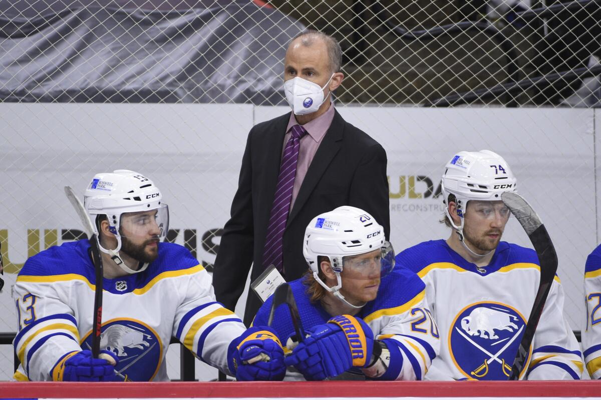 FILE - Buffalo Sabres interim head coach Don Granato watches from the bench during an NHL hockey game against the Philadelphia Flyers in Philadelphia, in this Sunday, April 11, 2021, file photo. Tony Granato can now laugh in recalling how angry he was at his brother Don for giving up goaltending at 15 and switching to forward. That might have been the last time Tony questioned his brother’s life decisions. (AP Photo/Derik Hamilton, File)
