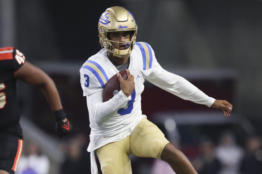 UCLA quarterback Dante Moore (3) slips a tackle by Oregon State linebacker.