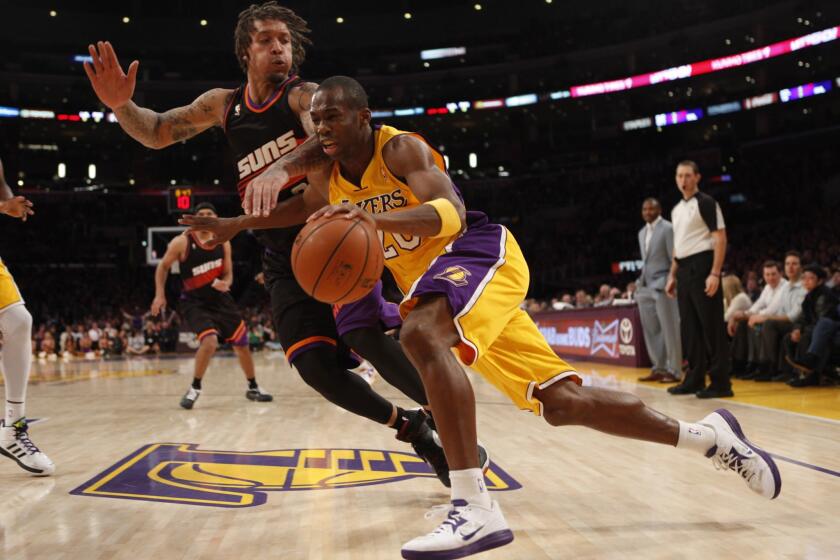 Michael Beasley, left, guards Jodie Meeks during a game at Staples Center in 2013. The Lakers brought in Beasley for a second workout, the free-agent forward's agent confirmed on Thursday.