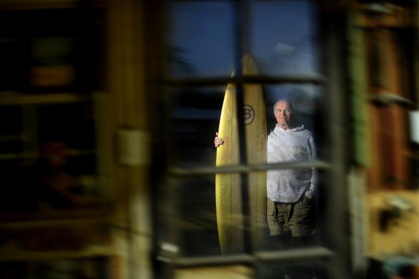 -CA-MAY 19, 2021: Surfer Bob Levy stand-in his back yard in Long Beach with one of his surfboards. He traveled by car with friends to El Salvador back in the 70Os to discover surfing. (Wally Skalij / Los Angeles Times)