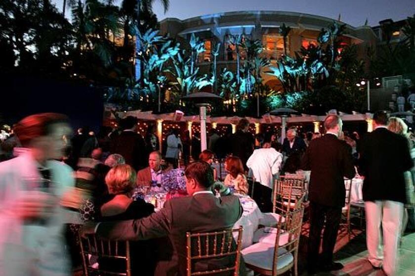 Guests take their seats for dinner at the Yves Saint Laurent "Pool Party" at the Beverly Hills Hotel to benefit Center Dance Arts.