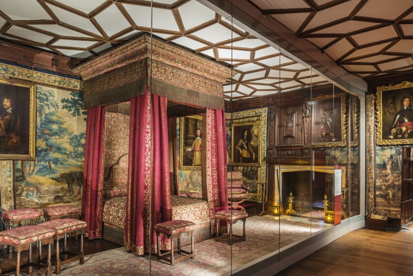 The historic home Knole, owned by the Sackville family, has a collection of royal furniture that includes this canopied bed.