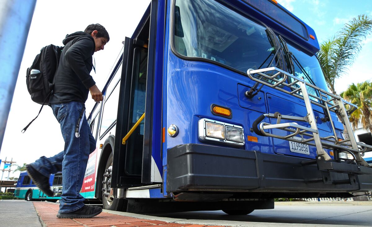 A man gets on a Breeze bus at the Oceanside Transit Center.