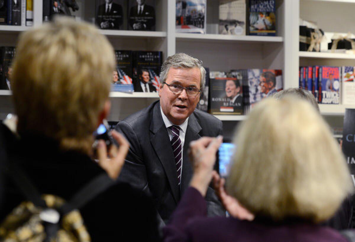 Former Florida governor Jeb Bush autographs his new book "Immigration Wars: Forging an American Solution" before speaking at the Reagan Library.