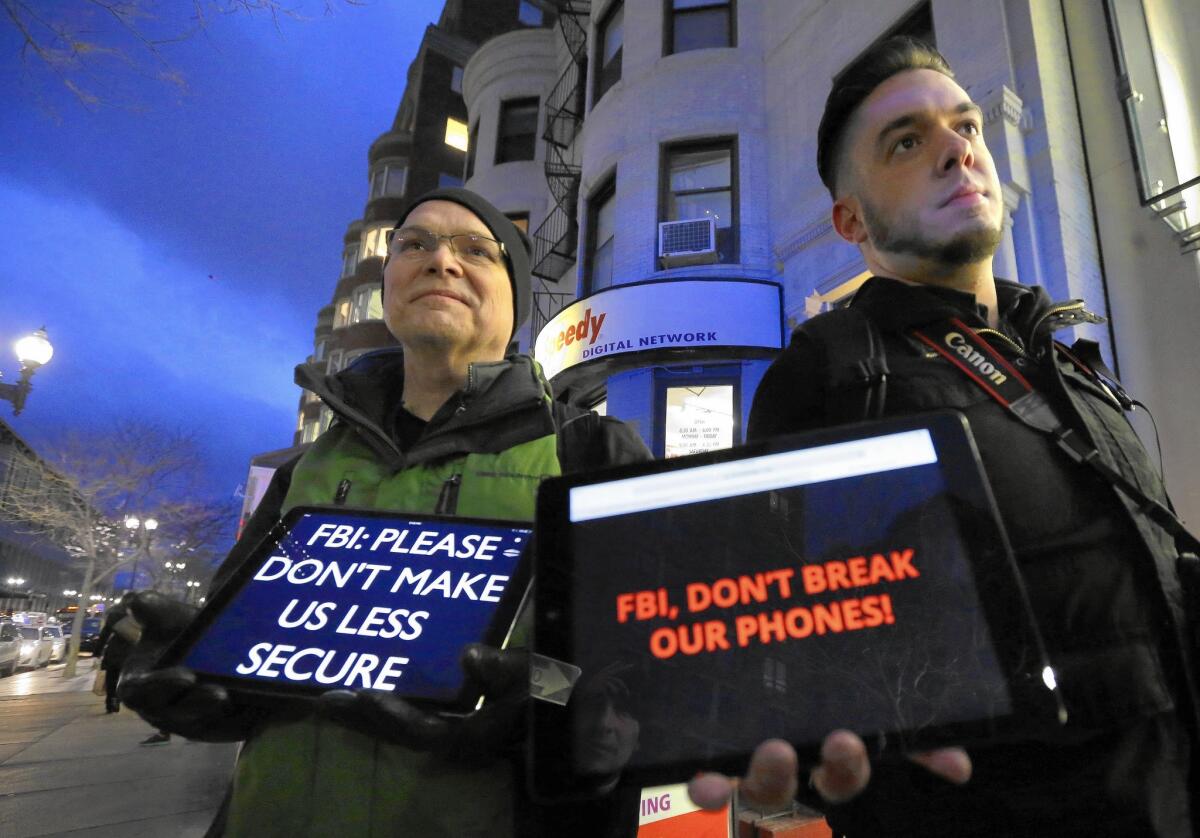 Attorneys for Apple say they plan to insist that the government explain how investigators bypassed an iPhone 5c's security. Above, demonstrators in Boston last month.