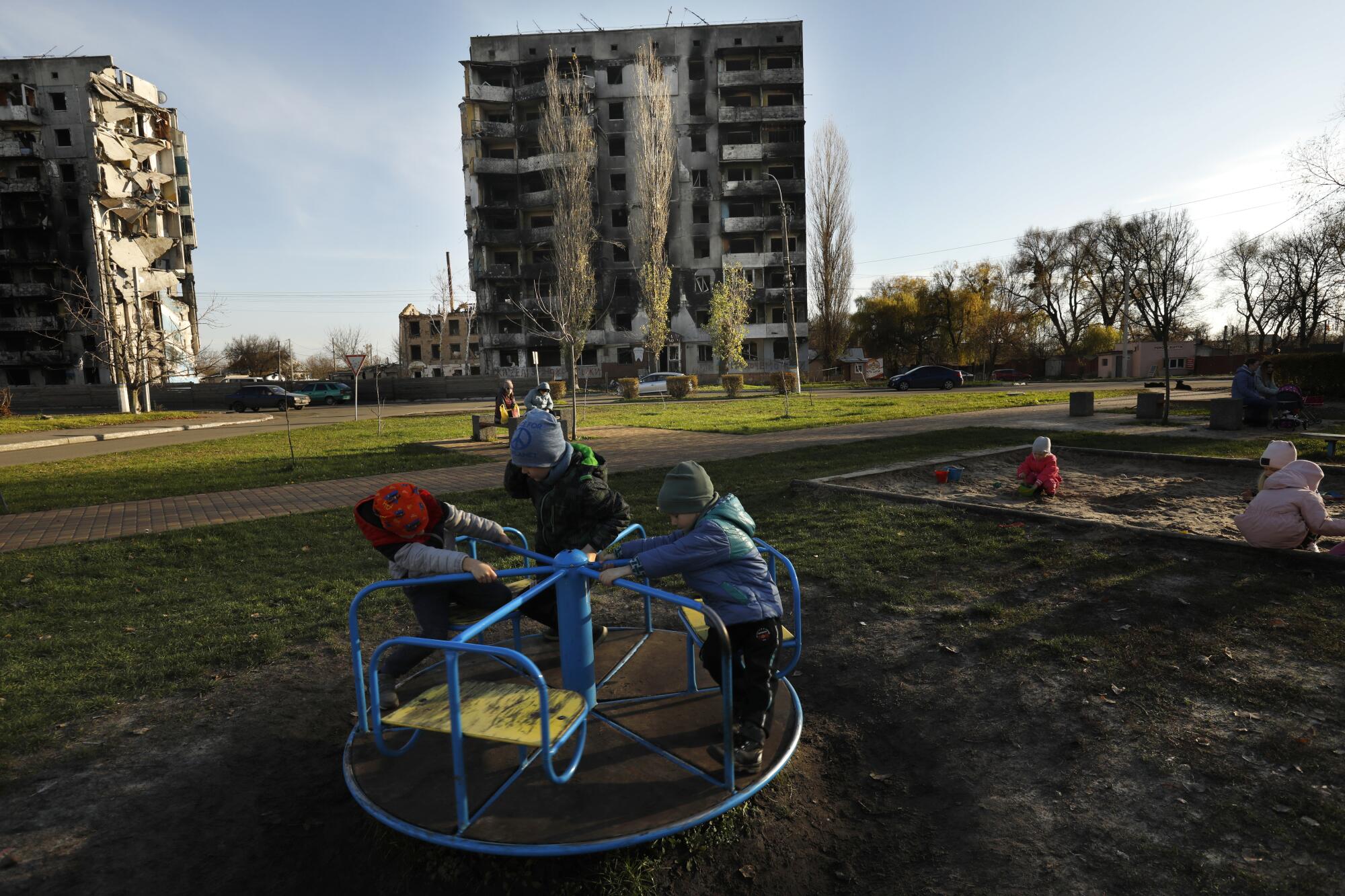 Children play on a merry-go-round 