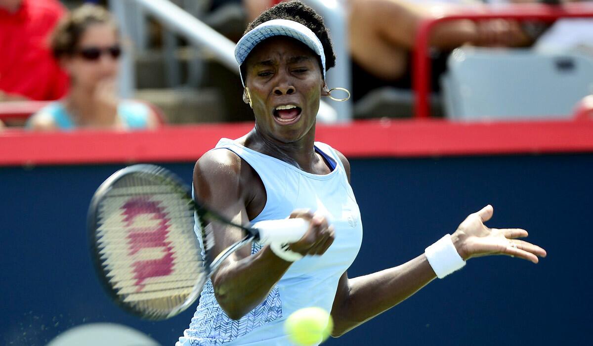 Venus Williams returns a shot against Agnieszka Radwanska during the championship match of Rogers Cup on Sunday in Montreal.