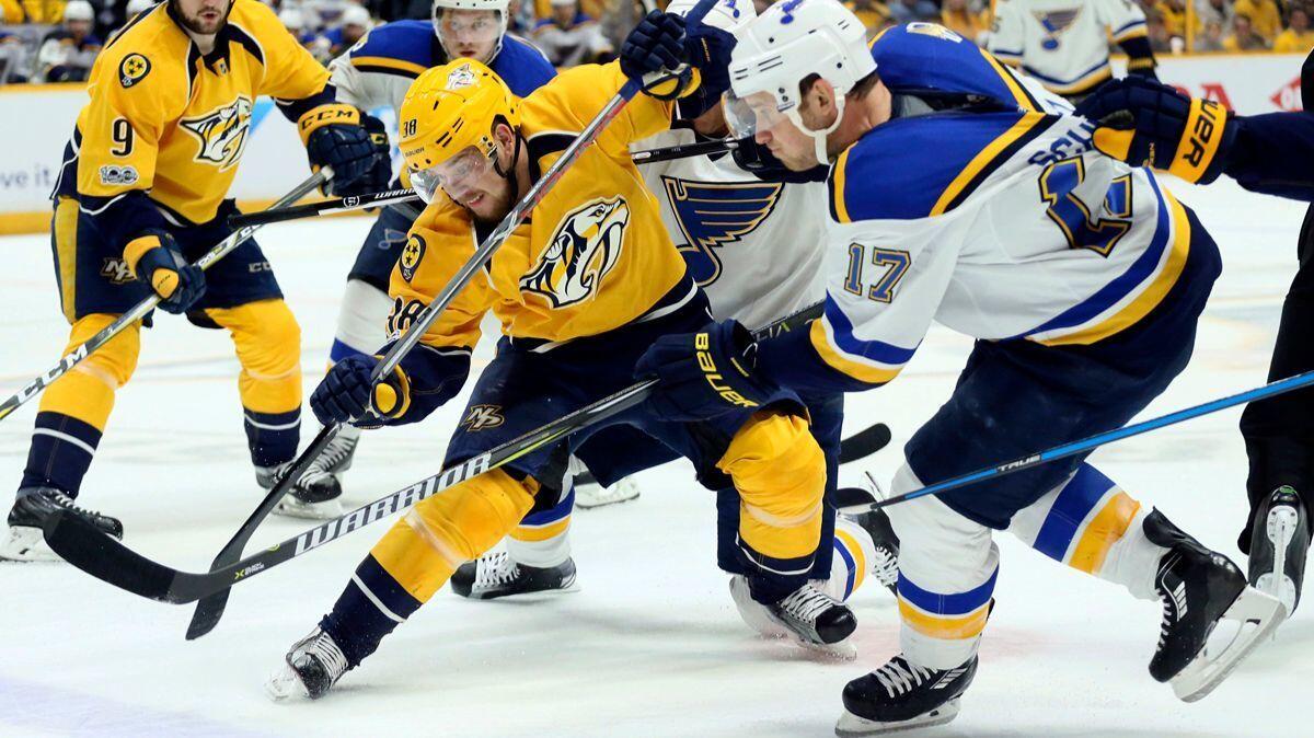 Nashville Predators left wing Viktor Arvidsson, center left, competes for the puck against St. Louis Blues left wing Jaden Schwartz (17) in the first period of Game 3 of their Stanley Cup playoff series, Sunday.
