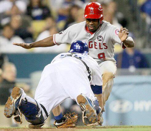 Angels third baseman Chone Figgins puts on the brakes before he can be tagged by Dodgers catcher Russell Martin in the seventh inning. Figgins was caught in a rundown when he broke for home on a grounder that shortstop Rafael Furcal snagged.