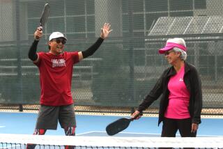LOMA LINDA, CA - NOVEMBER 30, 2023 - Dr. Loida Medina, 85, right, and her son Ernie Medina, 58, celebrate a point during a game of pickleball at the Loma Linda University Drayson Center in Loma Linda on November 30, 2023. Dr. Medina, retired from working at Loma Linda University Medical Center, plays pickleball three days a week. Dr. Medina, a member of the Seventh Day Adventist Church, believes in a healthy, active lifestyle. Loma Linda is considered to be one of many Blue Zones in the world where longevity of life is found in seniors in these communities. Blue zones are regions in the world where people are claimed to live, or to have recently lived, longer than average. A recent Netflix mini series, "Live to 100: Secrets of the Blue Zones," claims Loma Lindans live longer due to faith, diet, and exercise. The notion is not based on scientific evidence but demographic anecdotes. (Genaro Molina / Los Angeles Times)