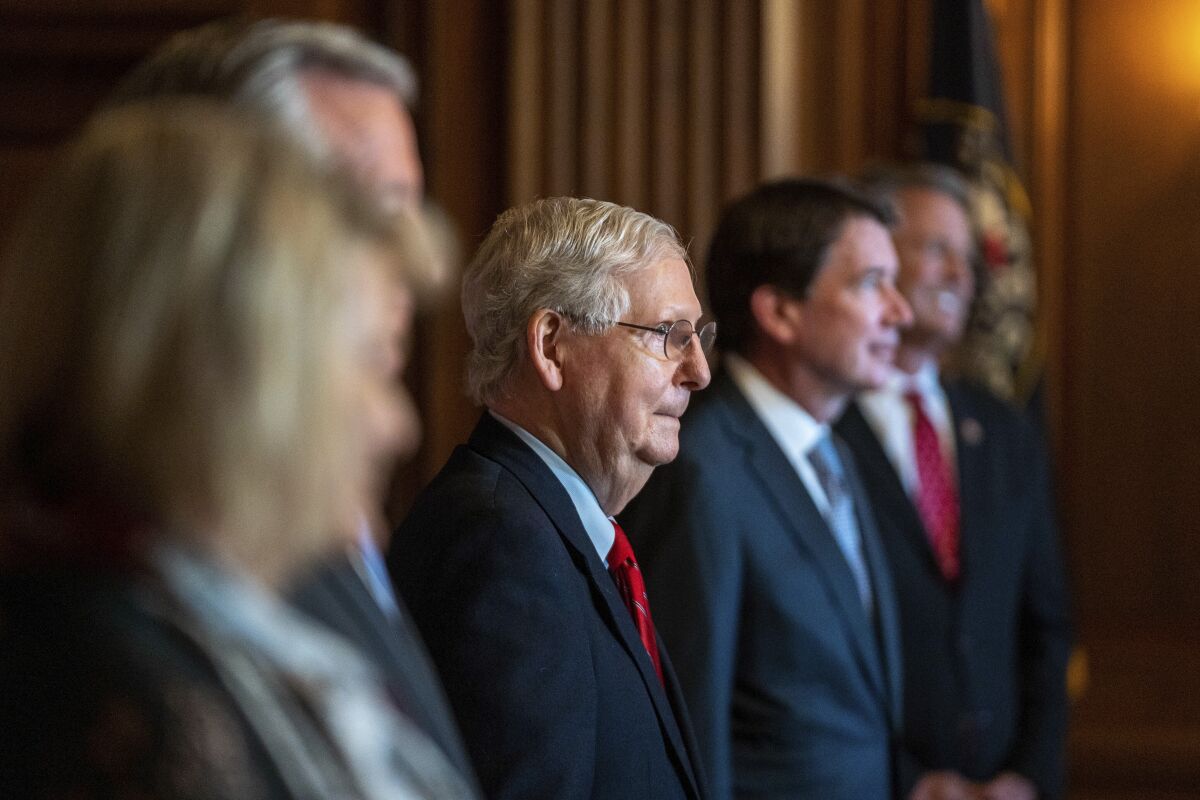 Senate Majority Leader Mitch McConnell (R-Ky.) poses with newly elected Republican senators on Monday.