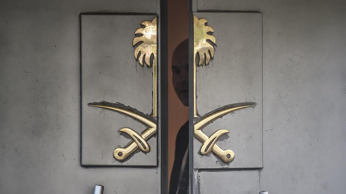 A Saudi official looks through the door of the Saudi Consulate in Istanbul, Turkey, on Oct. 8.