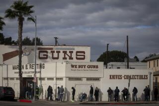 CULVER CITY, CA MARCH 15, 2020: People line up outside Martin Retting store in Culver City, Ca March 15, 2020. Sporting goods and collectables including guns and knives are sold here. The line extends past the store front. (Francine Orr/ Los Angeles Times)