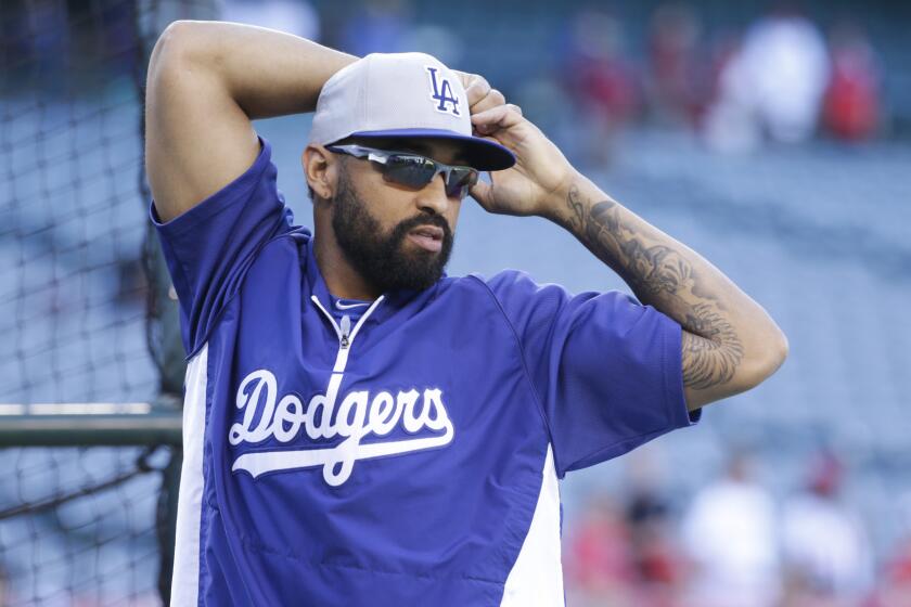 Dodgers outfielder Matt Kemp stretches before Wednesday's game against the Angels.