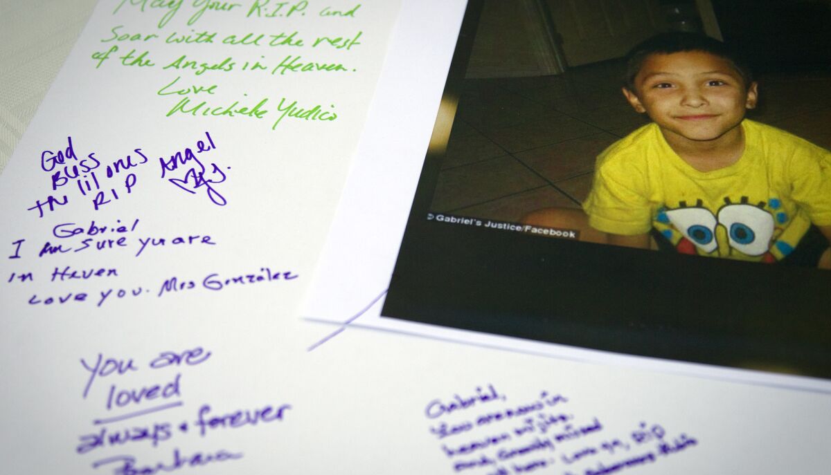 Tributes are written on a poster board during a memorial service last year for Gabriel Fernandez, 8, a Palmdale boy who was allegedly beat to death by his mother's boyfriend.
