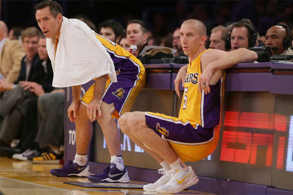 Steve Nash, left, and Steve Blake wait to rejoin the action during a Lakers preseason game against the Utah Jazz at Staples Center back in October. Both have been out for weeks with injuries.