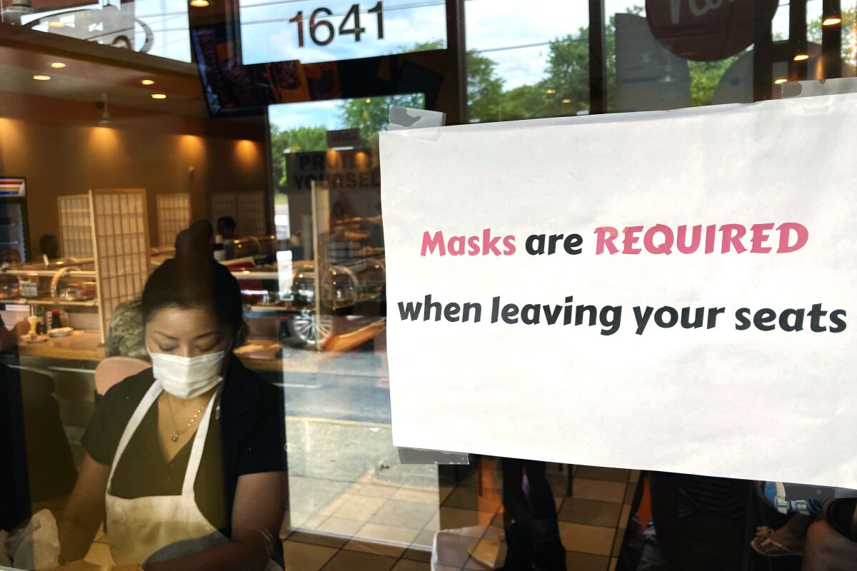 FILE - In this June 17, 2021, file photo, a sign requiring masks is displayed at a restaurant in Rolling Meadows, Ill. (AP Photo/Nam Y. Huh, File)