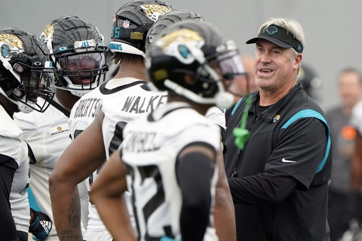 Jacksonville Jaguars head coach Doug Pederson, right, talks with players during an NFL football practice, Tuesday, May 31, 2022, in Jacksonville, Fla. (AP Photo/John Raoux)