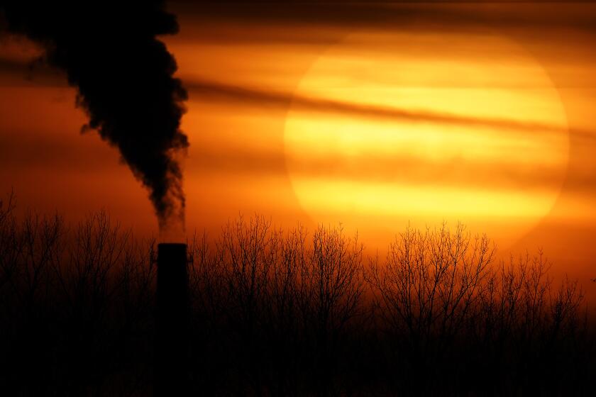 CORRECTS CITY TO KANSAS CITY FROM INDEPENDENCE - FILE - Emissions from a coal-fired power plant are silhouetted against the setting sun, Monday, Feb. 1, 2021, in Kansas City, Mo. (AP Photo/Charlie Riedel, File)