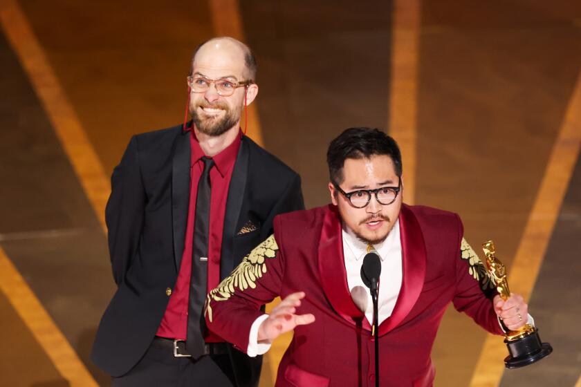 HOLLYWOOD, CA - MARCH 12: Daniel Scheinert and Daniel Kwan accept the award for Directing at the 95th Academy Awards in the Dolby Theatre on March 12, 2023 in Hollywood, California. (Myung J. Chun / Los Angeles Times)