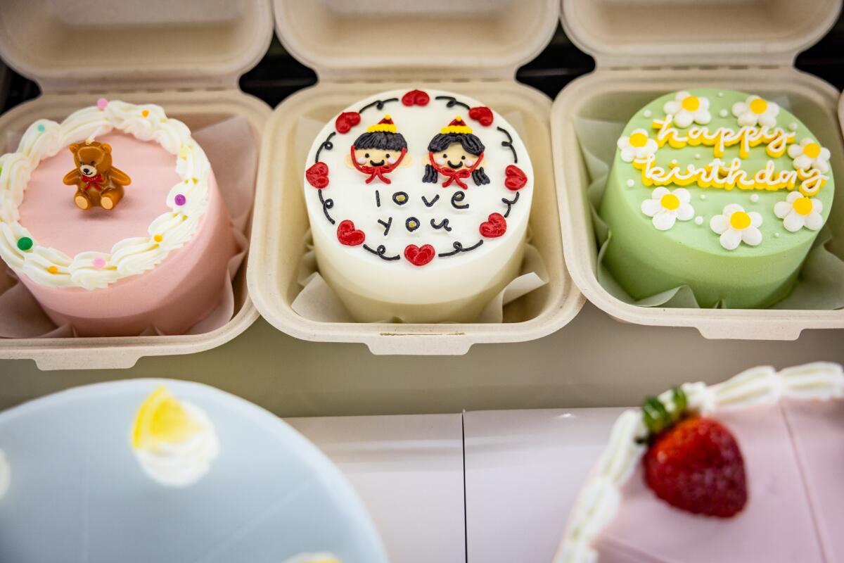 Decorated cakes in a case at Harucake, a Koreatown bakery that creates viral minimalist cakes.