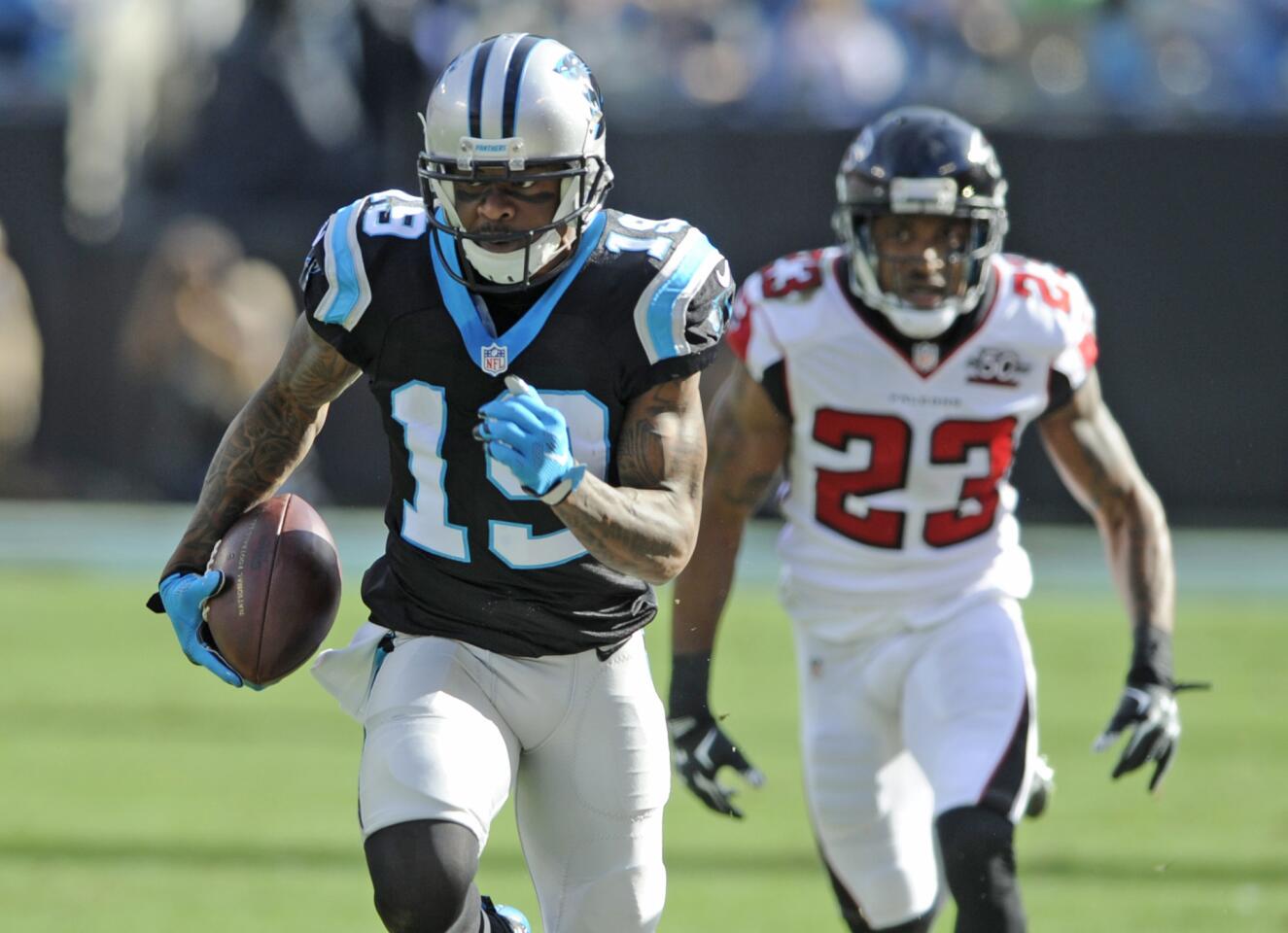 Carolina Panthers' Ted Ginn (19) runs past Atlanta Falcons' Robert Alford (23) for a touchdown after a catch in the first half of an NFL football game in Charlotte, N.C., Sunday, Dec. 13, 2015. (AP Photo/Mike McCarn)