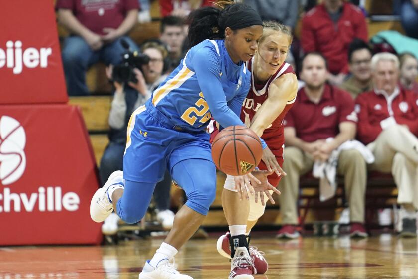 UCLA's Japreece Dean (24) steals the ball from Indiana's Ali Patberg (14) during the first half of an NCAA college basketball game, Sunday, Dec. 22, 2019 in Bloomington, Ind. (Bobby Goddin/The Herald-Times via AP)