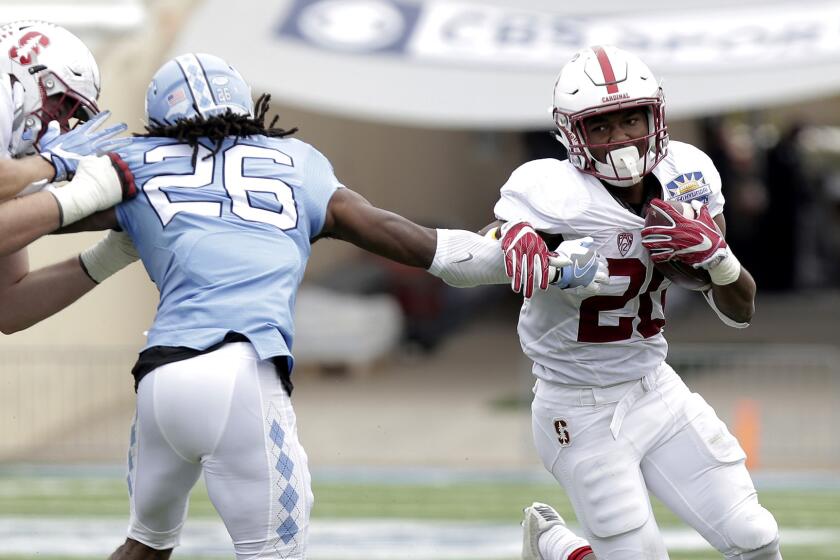 Stanford running back Bryce Love tries to evade North Carolina safety Dominiqie Green during the second quarter Friday.